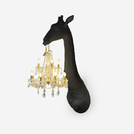 The black giraffe with a gold crystal chandelier on a pale background