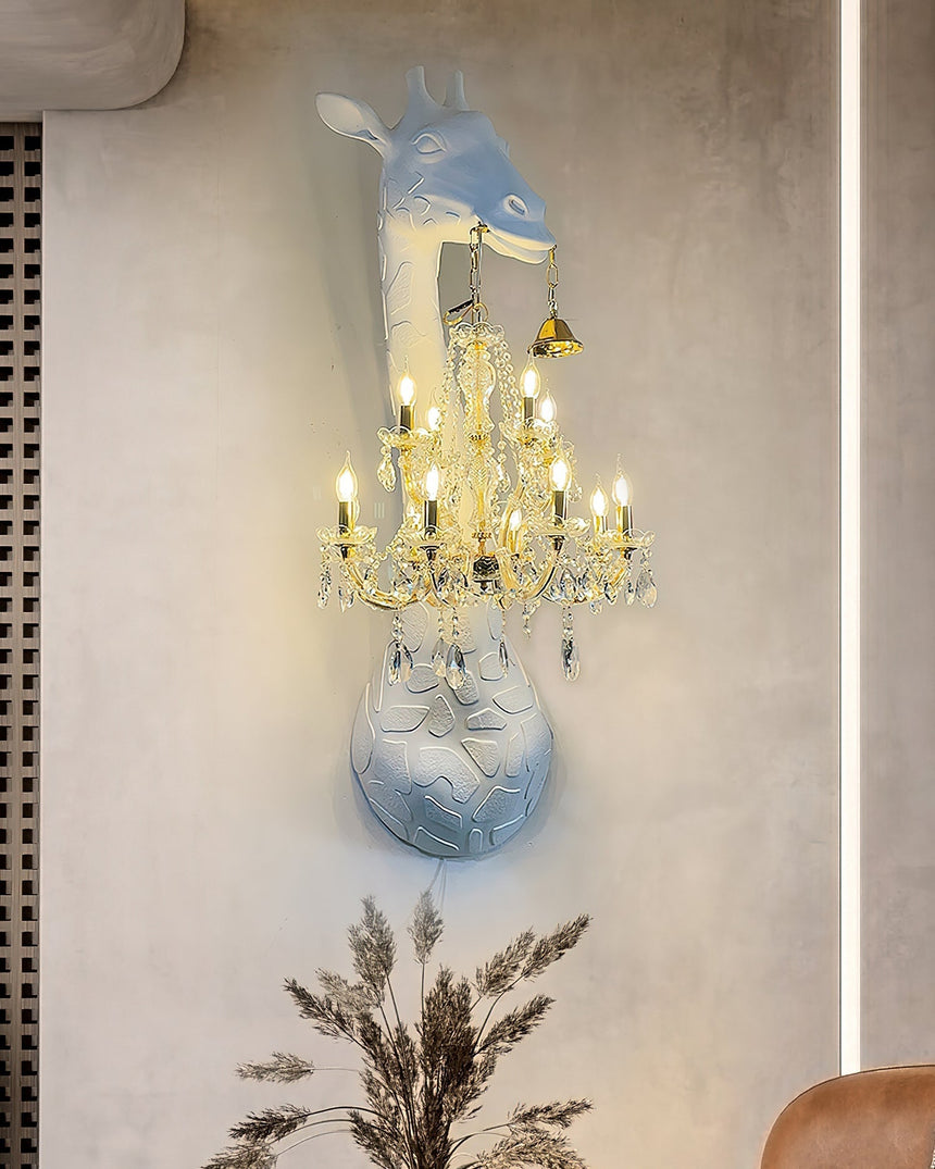 The giraffe lamp lit on a beige wall above a vase of pampas grass and a chair