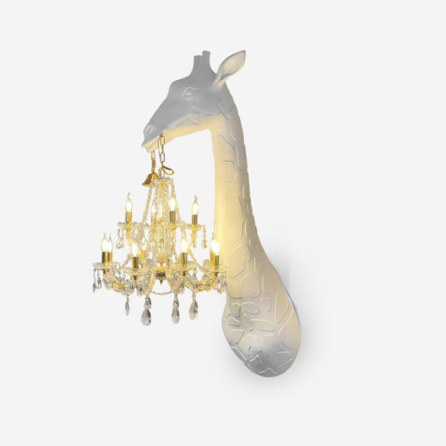 White giraffe head and neck sculpture on the wall holding a gold crystal chandelier