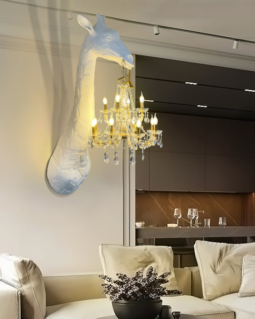The giraffe lamp lit above a cream sofa in an open living room with a kitchen behind