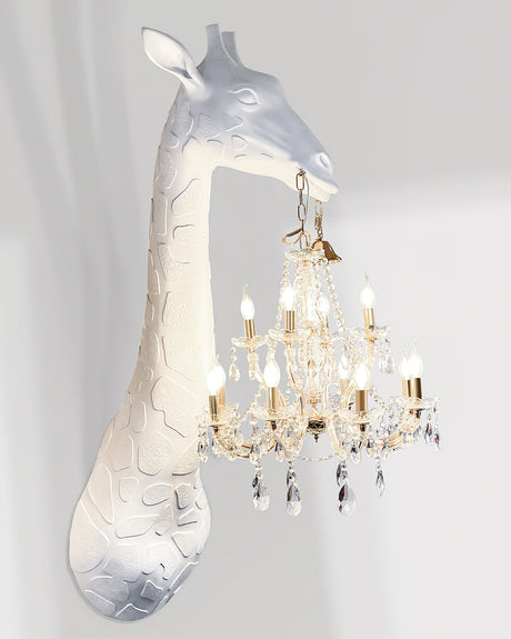 Side view of the white giraffe and the crystal chandelier hanging from its mouth