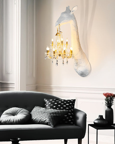 The giraffe lamp lit above a black sofa with patterned cushions