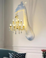 The giraffe lamp lit above a teal sofa with a patterned cushion