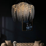 The fitting lit above a tufted sofa and a bust, with framed artwork behind