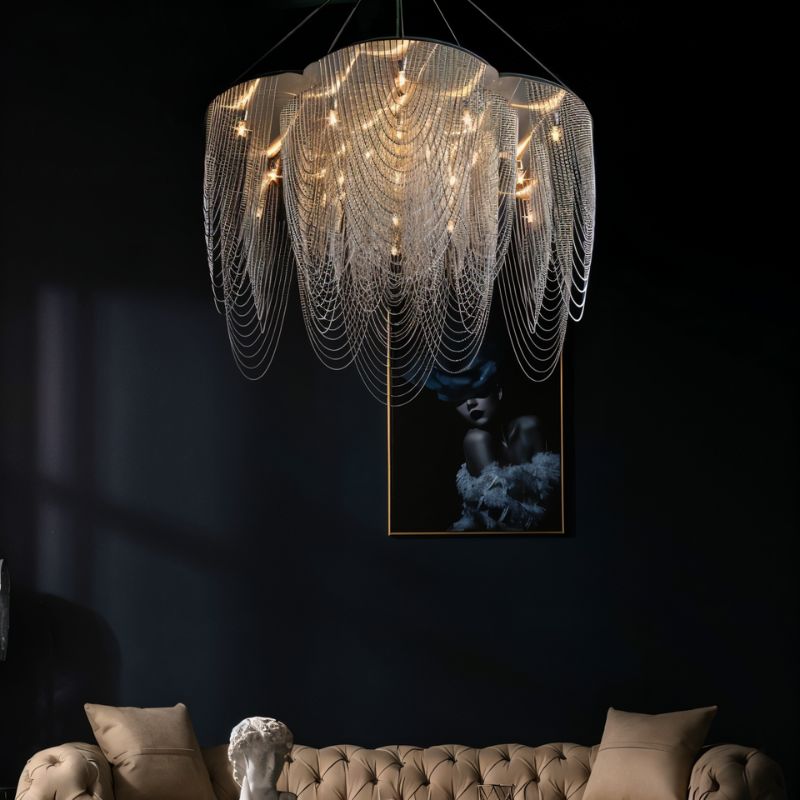 The fitting lit above a tufted sofa and a bust, with framed artwork behind