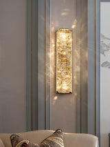 The gold version lit on a paneled wall above an armchair