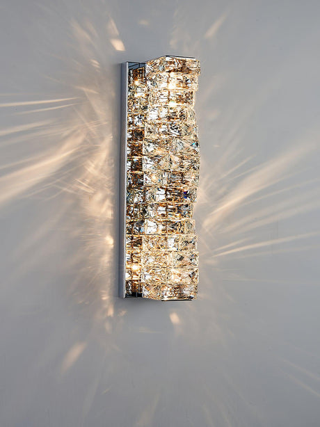 The chrome version lit on a pale wall, the blocks sparkling