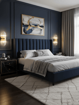 A pair of rod sconces lit on each side of a navy upholstered bed