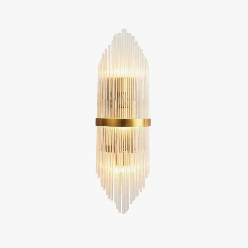 Tall wall sconce of clear crystal rods around a brass band, lit up and down