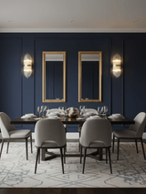 Rod sconces on each side of two tall mirrors in a navy dining room