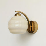 The gold version with a beige ribbed glass globe