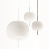 Three opal glass balls hung at different heights on slim rods