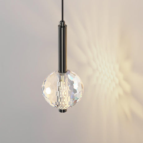 The faceted ball lit, casting a pattern of light on the wall