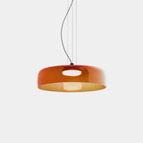 Orange one tier glass shade on a plain background