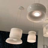 White glass pendants seen from below, the light spread evenly across the shade