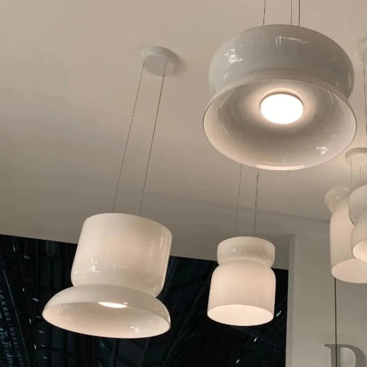White glass pendants seen from below, the light spread evenly across the shade