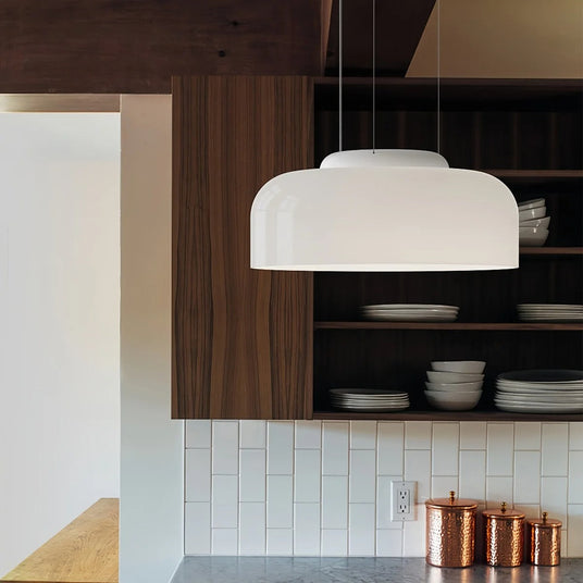 White jade glass pendant above a kitchen island with dark cabinetry