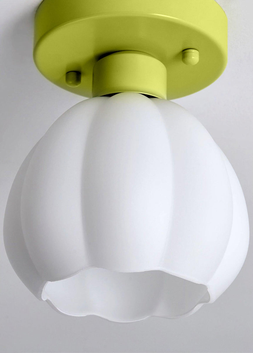 White glass flower shade seen from below against a plain gray background