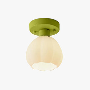 Flower shade semi flush ceiling light lit, shown against a plain background