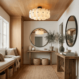 Fluted glass ceiling light in an entryway with a round mirror and a wood console