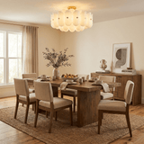 Fluted glass semi flush light over a long dining table with upholstered chairs