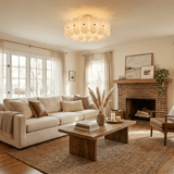 Fluted glass semi flush light in a living room with a sofa and a brick fireplace