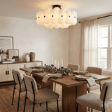 Fluted glass ceiling light above a dining table with a sideboard and candlesticks