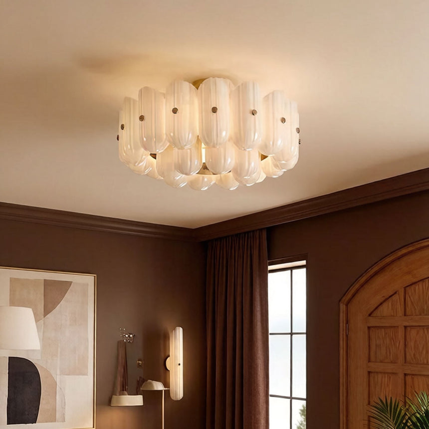 Fluted glass ceiling light in a room with dark red walls and an arched door