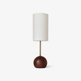 Globe table lamp with a walnut sphere base and a tall white shade, plain background