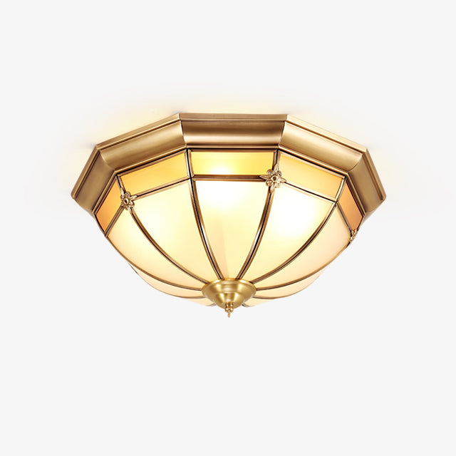 Gold and white ceiling light with a faceted brass dome and white glass panels