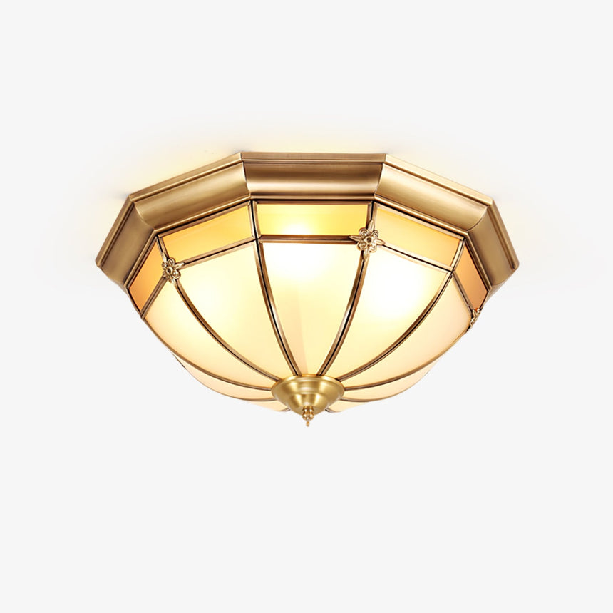 Gold and white ceiling light with a faceted brass dome and white glass panels