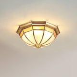 Faceted brass dome ceiling light lit against a plain ceiling