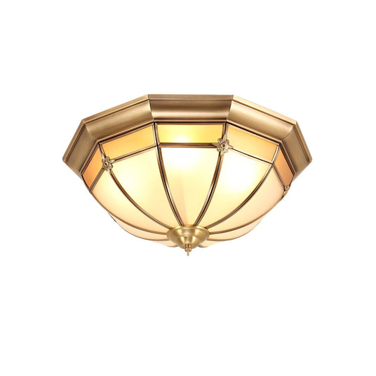 Faceted brass dome ceiling light shown unlit on a white backdrop