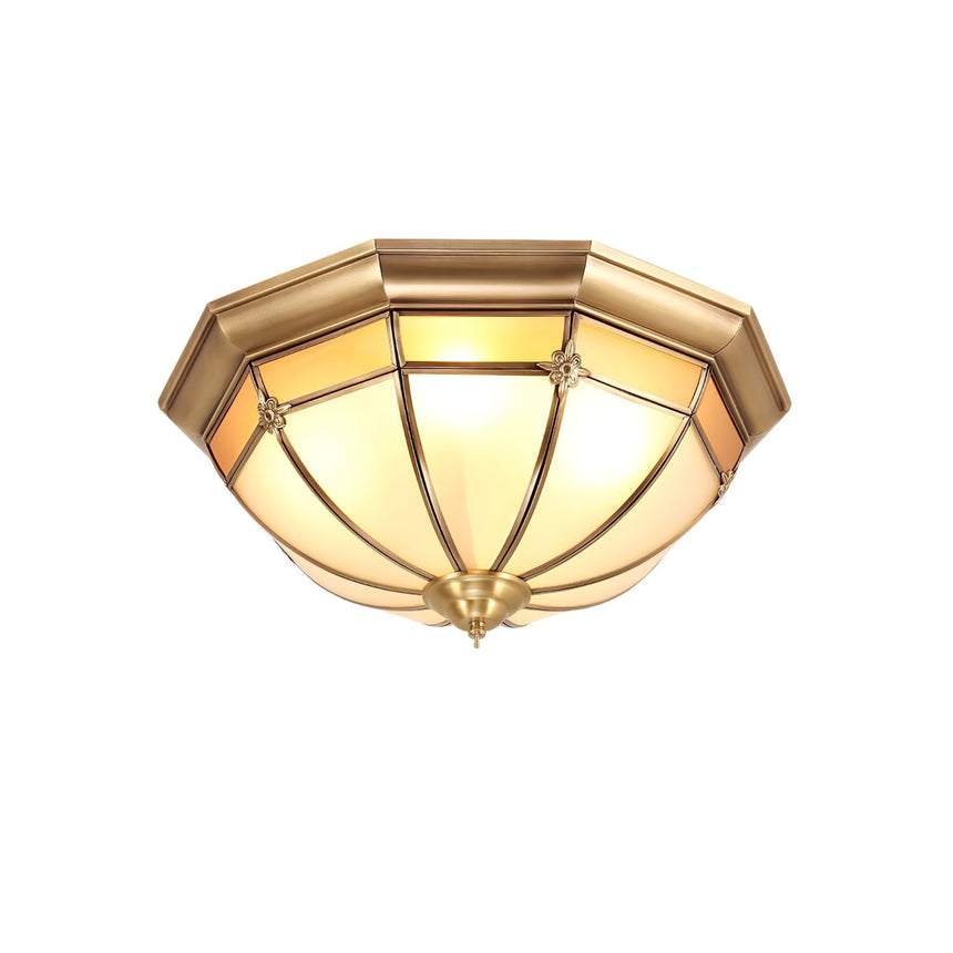 Faceted brass dome ceiling light shown unlit on a white backdrop