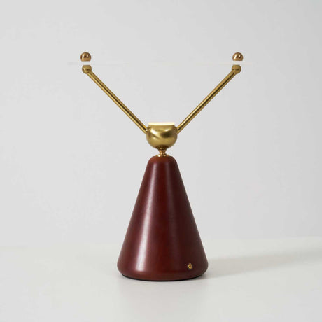 The two brass arms of the lamp seen from the front, plain ground
