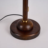 Close view of the round walnut foot and the gold collar