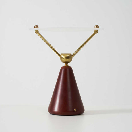 The wood cone base of the lamp seen against a plain ground