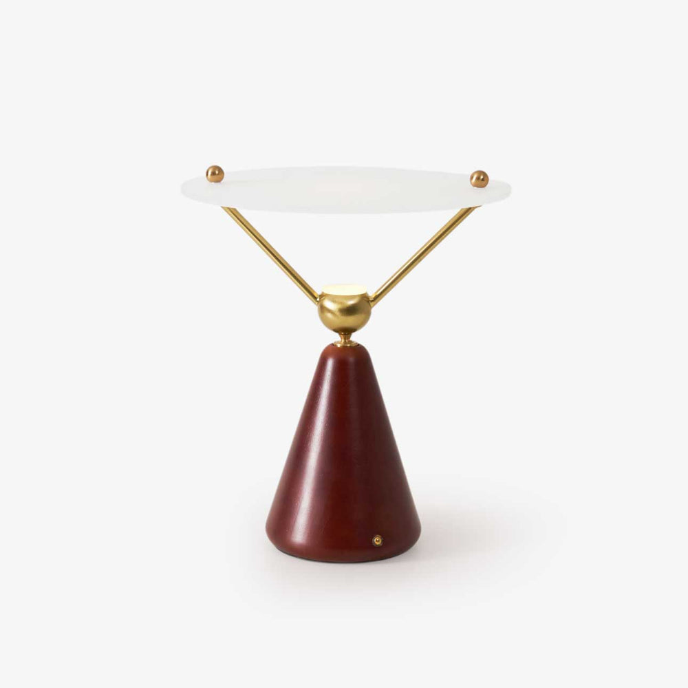 Gold and white table lamp with a floating disc on brass arms, plain ground