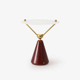 Gold and white table lamp with a floating disc on brass arms, plain ground