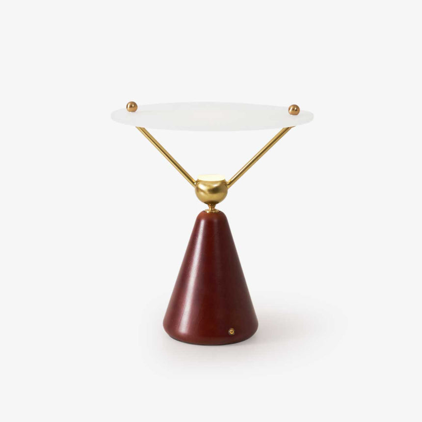 Gold and white table lamp with a floating disc on brass arms, plain ground