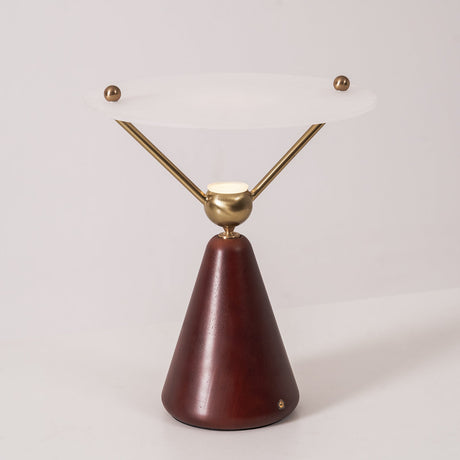 Gold and white table lamp seen straight on against a plain ground