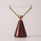 Gold and white table lamp seen in full against a plain ground