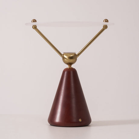 Gold and white table lamp seen in full against a plain ground