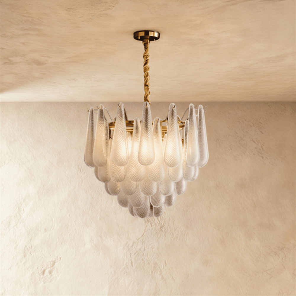 A gold chandelier with tiers of patterned glass petals falling in a shallow cone