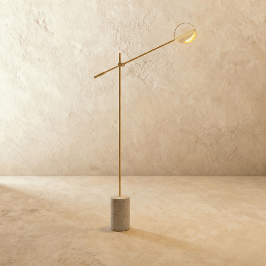 The same balanced arm in gold with a shallow disc shade at its far end