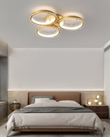 Three ring gold ceiling light in a bedroom with sheer curtains