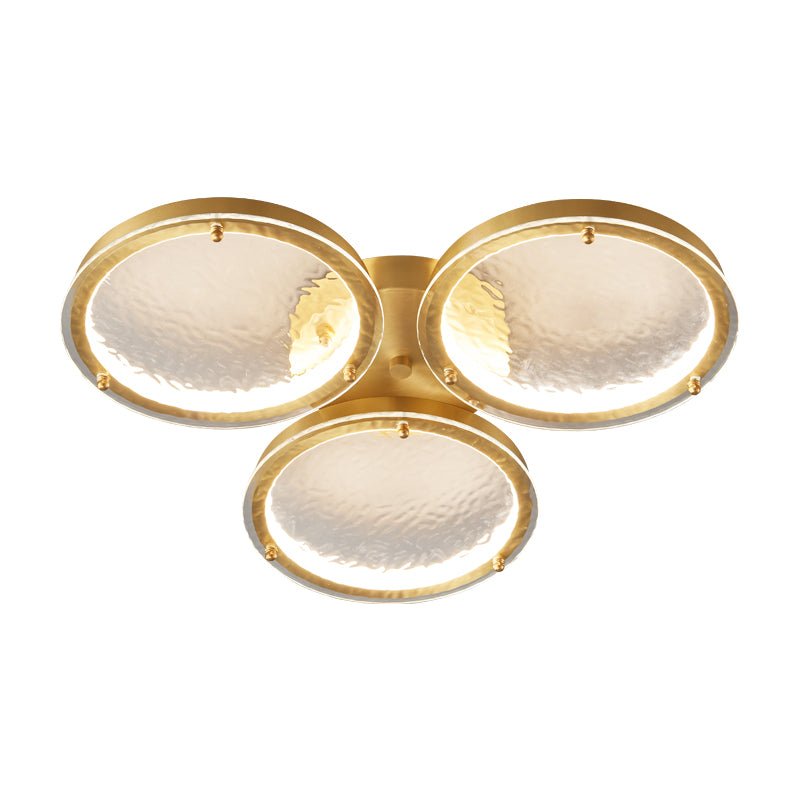 Smaller three ring gold ceiling light on a white backdrop