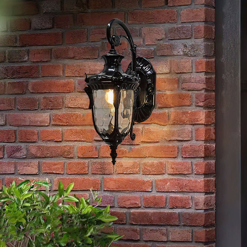The black finish lit on a red brick wall above a green shrub