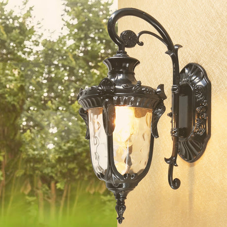 The black finish lit on a stucco wall with trees behind