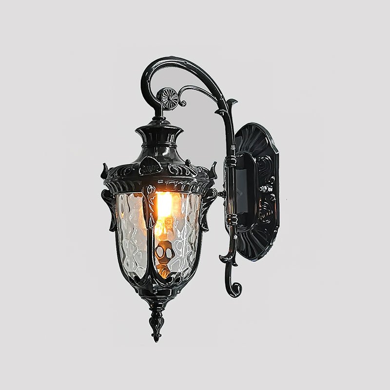 The black finish on a gray background, showing the carved details and scroll arm